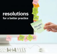computer monitor with sticky notes of new years resolutions