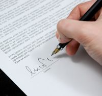 pen signing paper